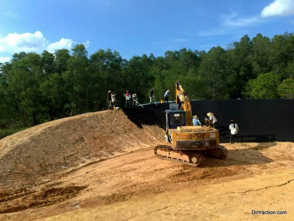 excavator assisted asphalt laying